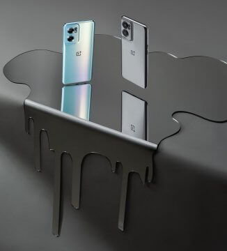Phones floating just above pool of liquid on edge of table